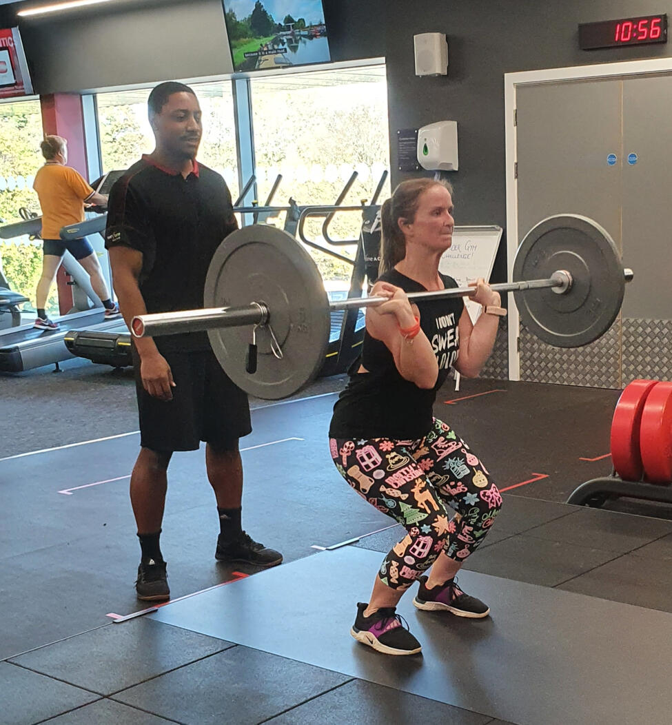 Personal trainer coaching a client during a gym session in Derby